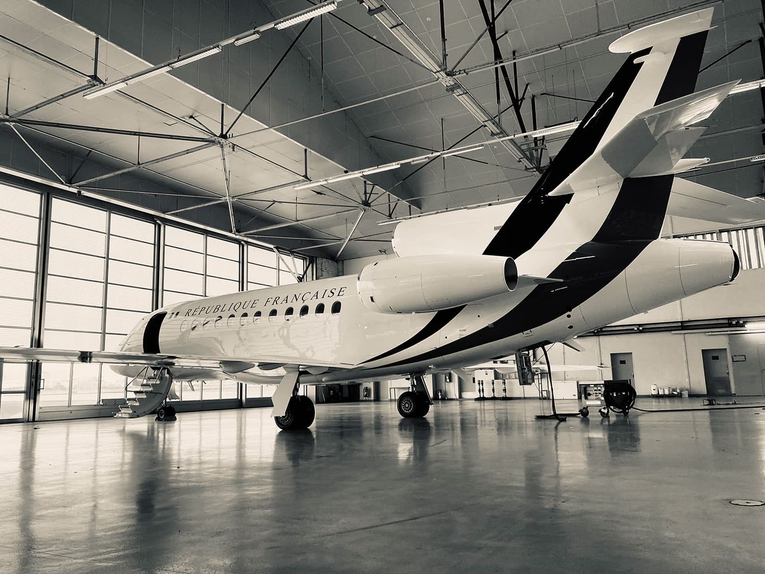 Falcon aircraft of the French Republic parked in a secure hangar, undergoing maintenance by Sabena technics